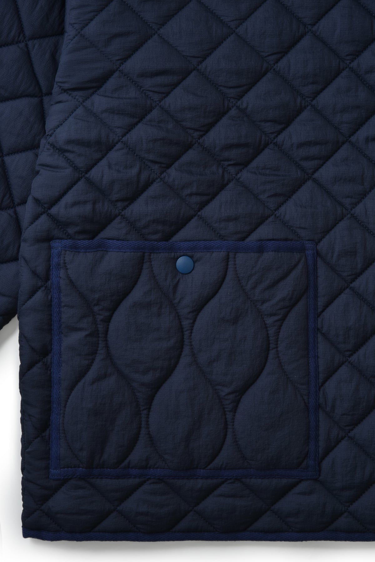 Navy quilt with diamond pattern on a white background