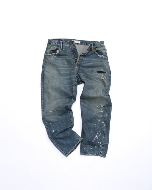 Distressed blue jeans on a white background