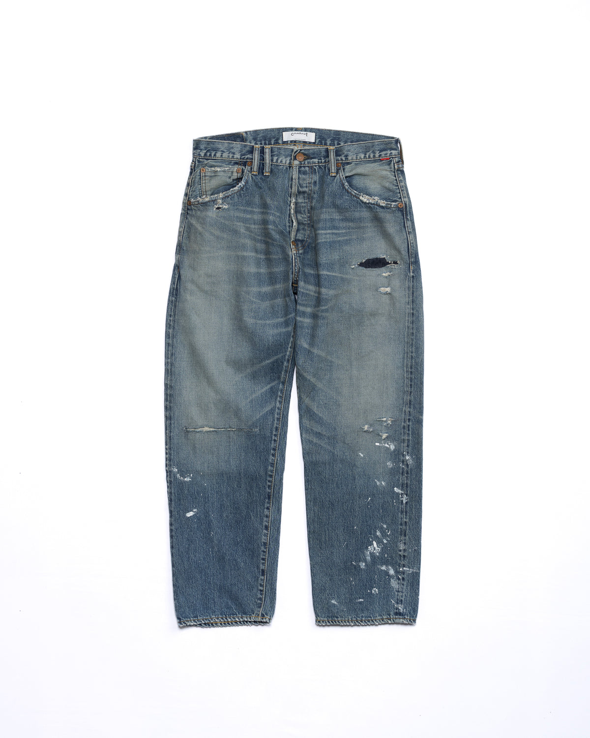 Blue jeans with slight distressing on a white background