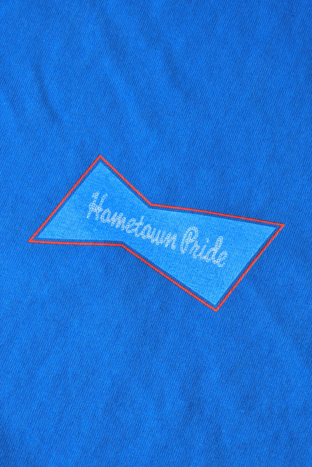 Blue fabric with 'Hometown Pride' embroidery on a blue background