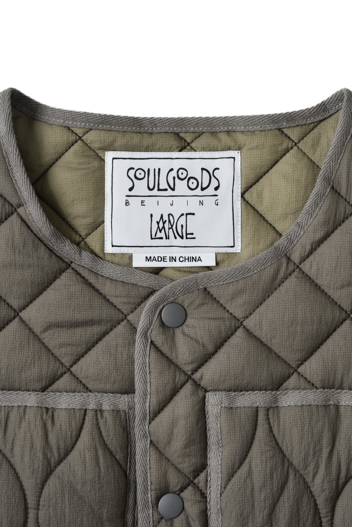 Quilted jacket with a visible label on a white background