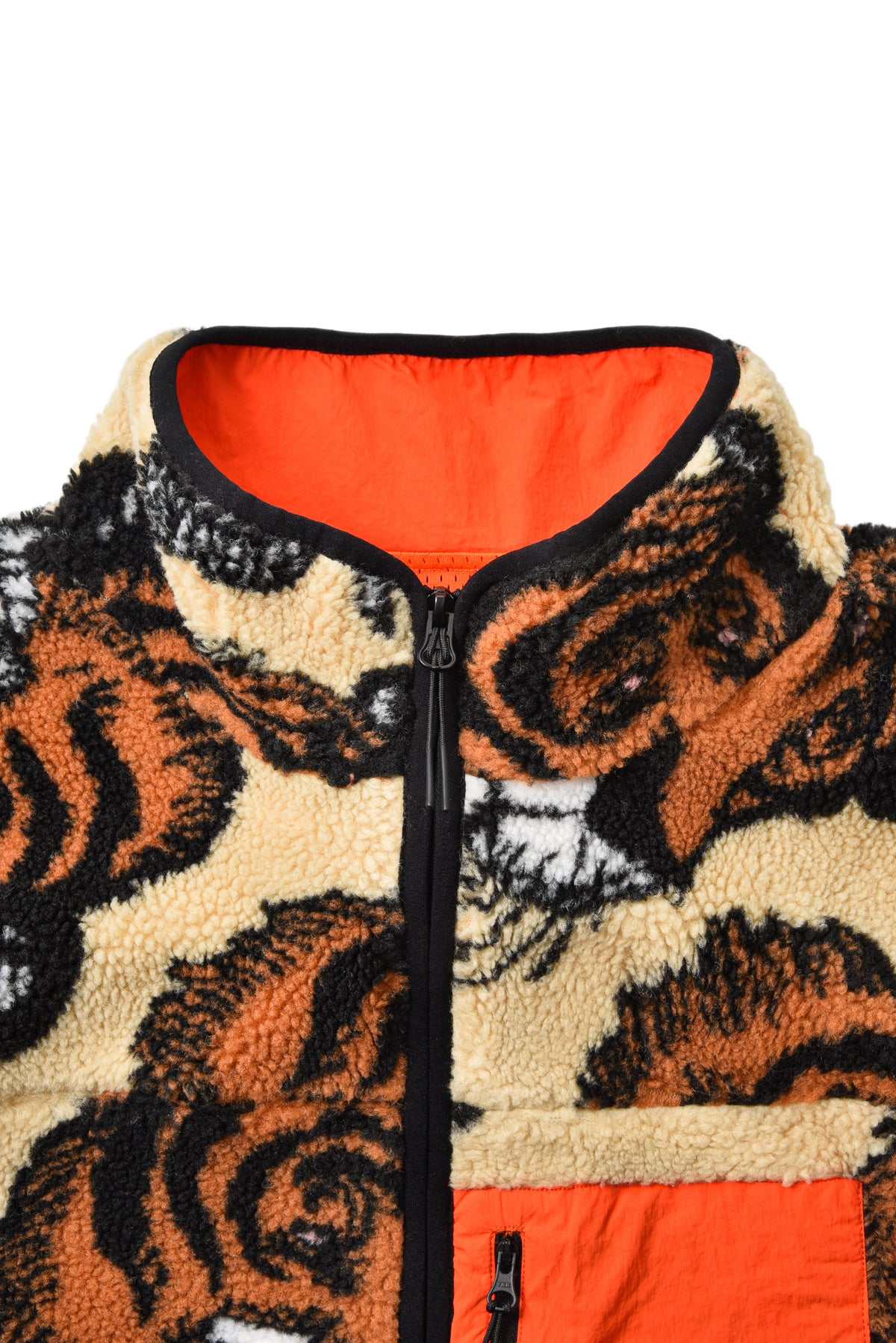Fleece jacket with tiger pattern and orange interior on a white background