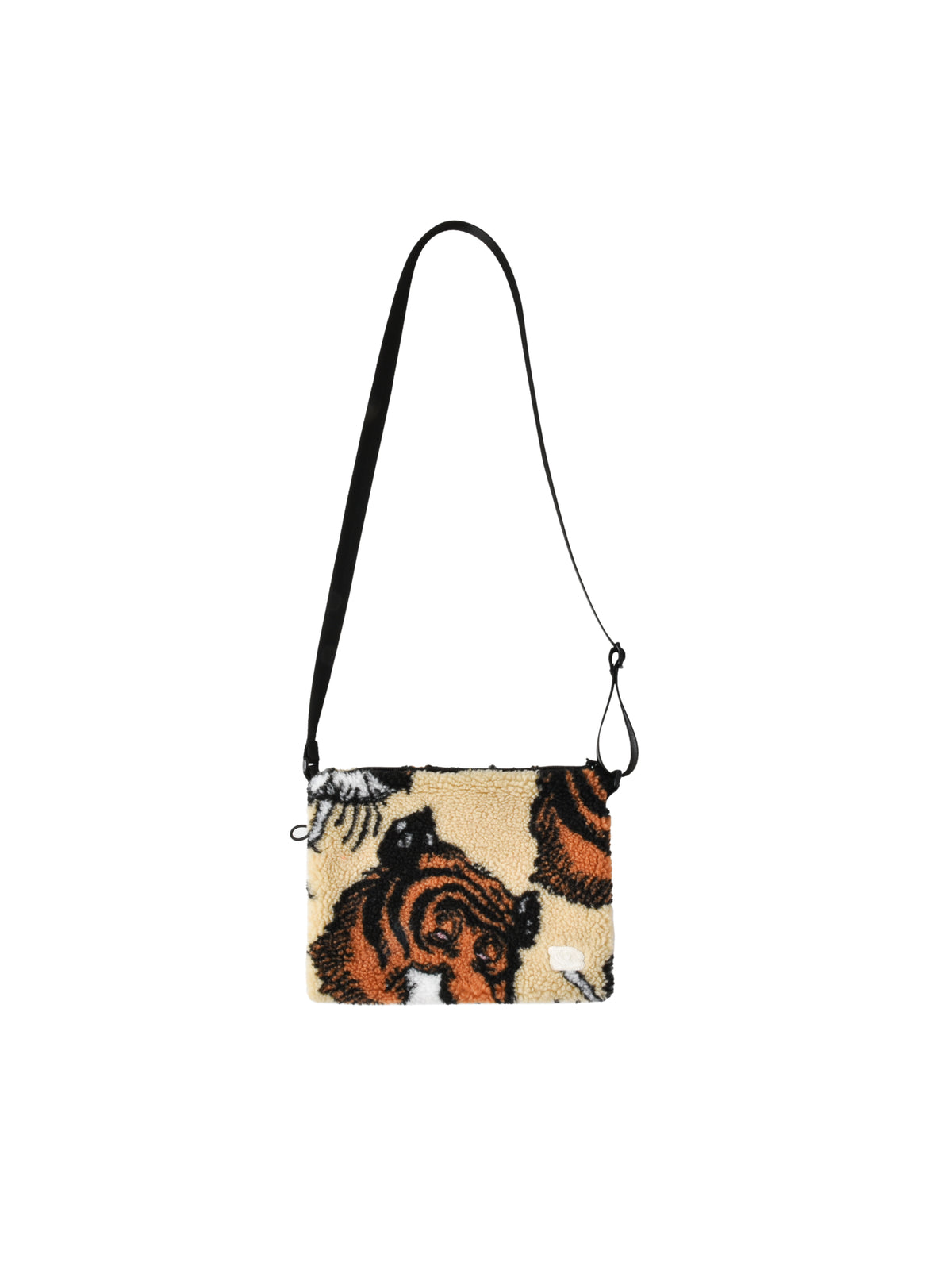 Crossbody bag with tiger design on a beige background