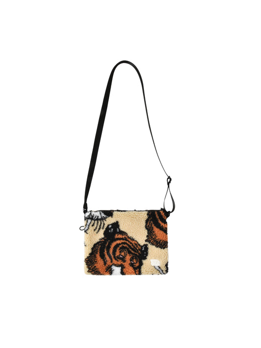 Crossbody bag with tiger design on a beige background