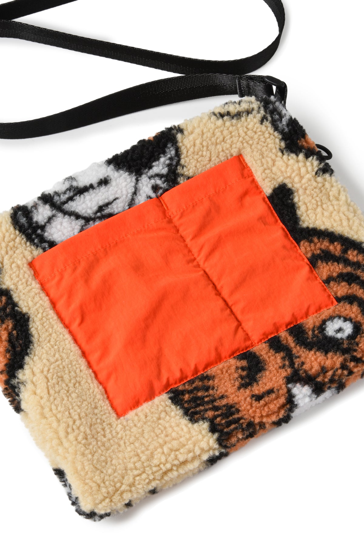 Crossbody bag with tiger pattern and orange interior pocket on a white background