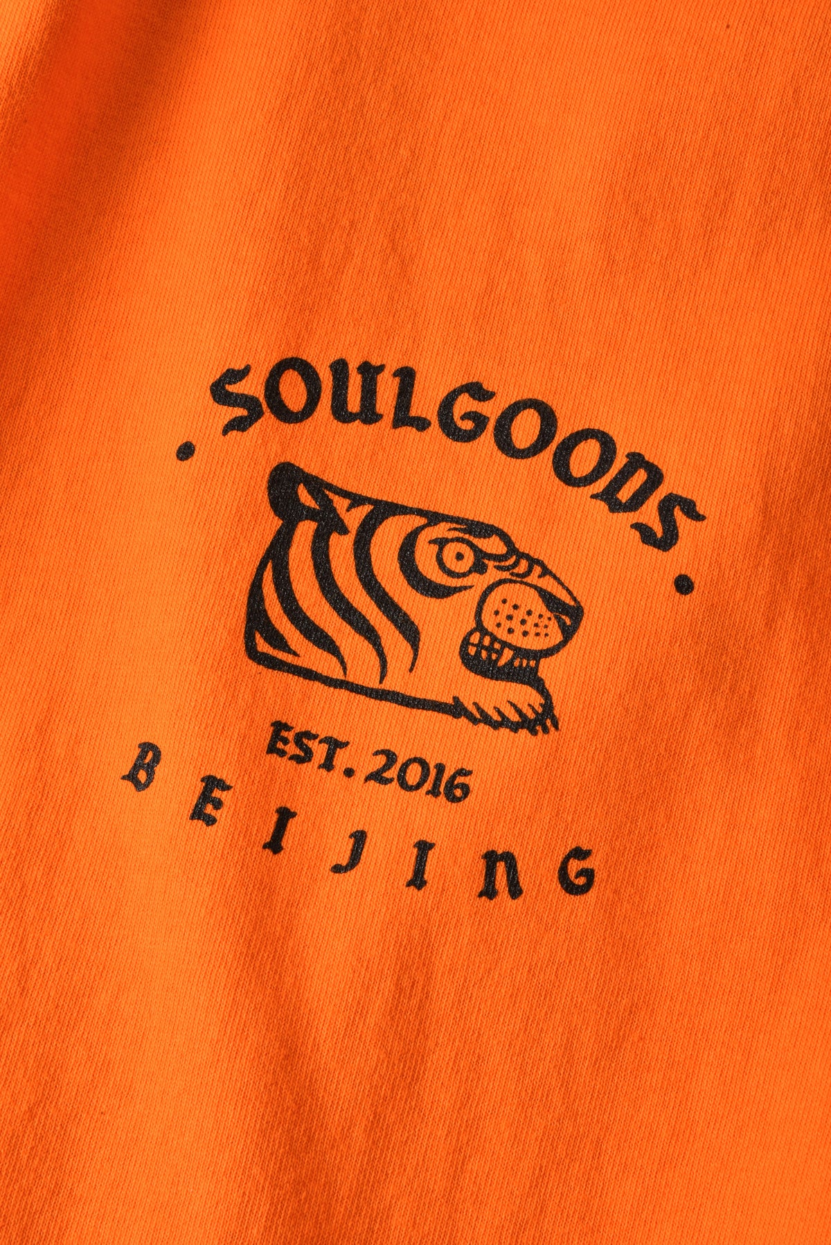 Orange fabric with black 'Soulgoods' logo featuring a tiger and text 'Est. 2016 Beijing'.