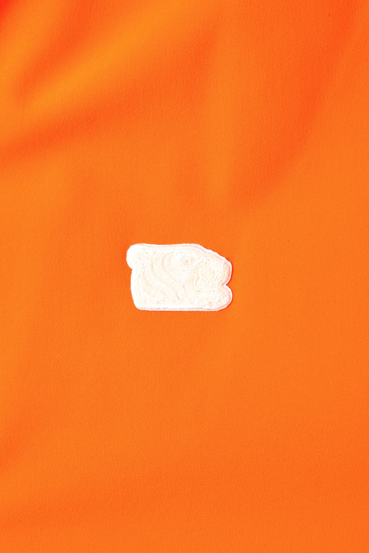 Small white tiger head logo on an orange background