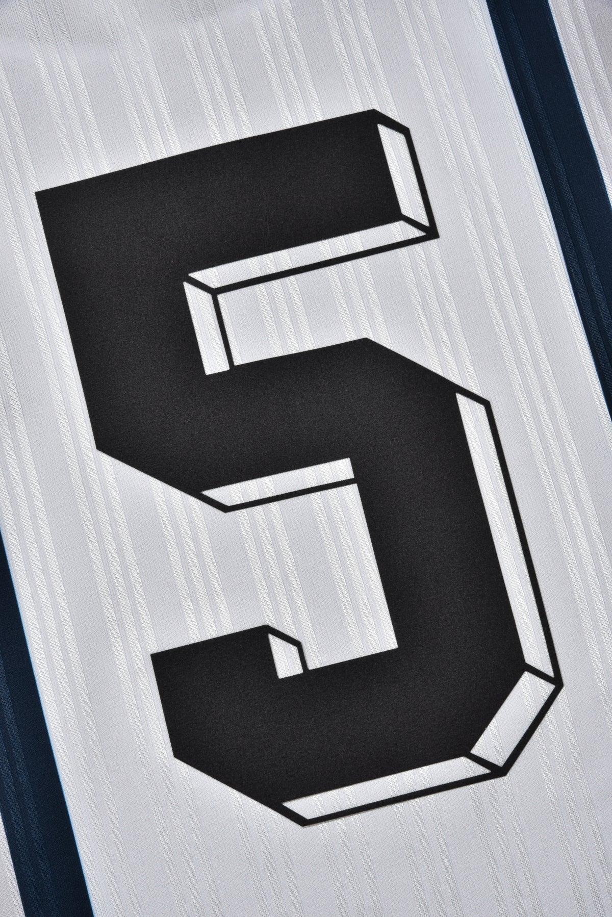 Black number '5' on a textured white background