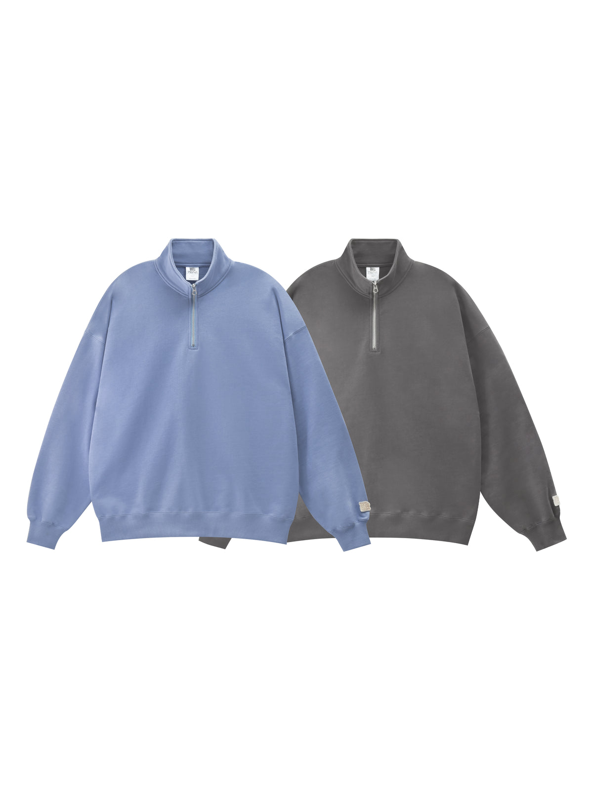 Two half-zip sweatshirts, one blue and one gray, on a white background.