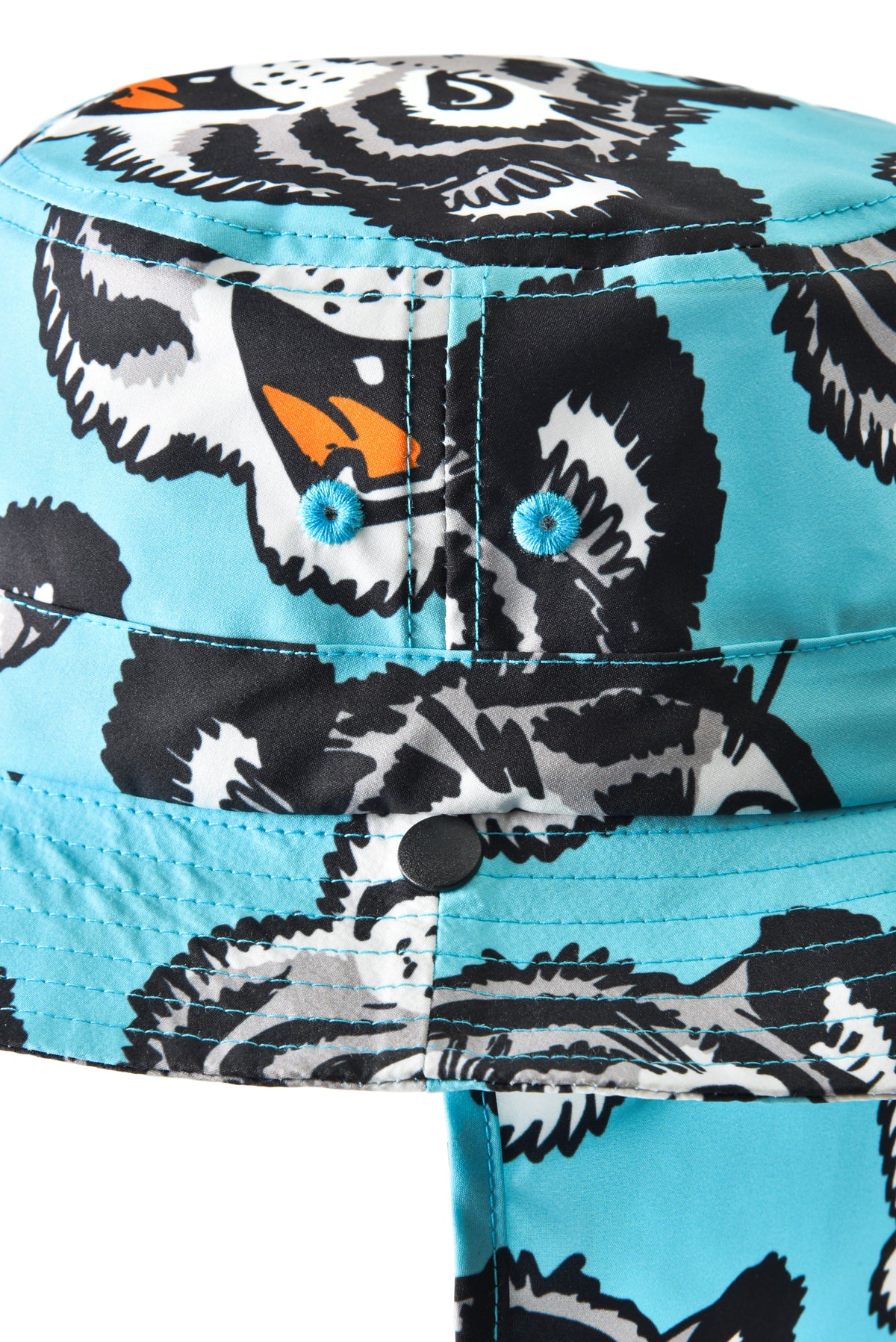 Close-up of a cute tiger patterned hat with black and white designs on a blue background