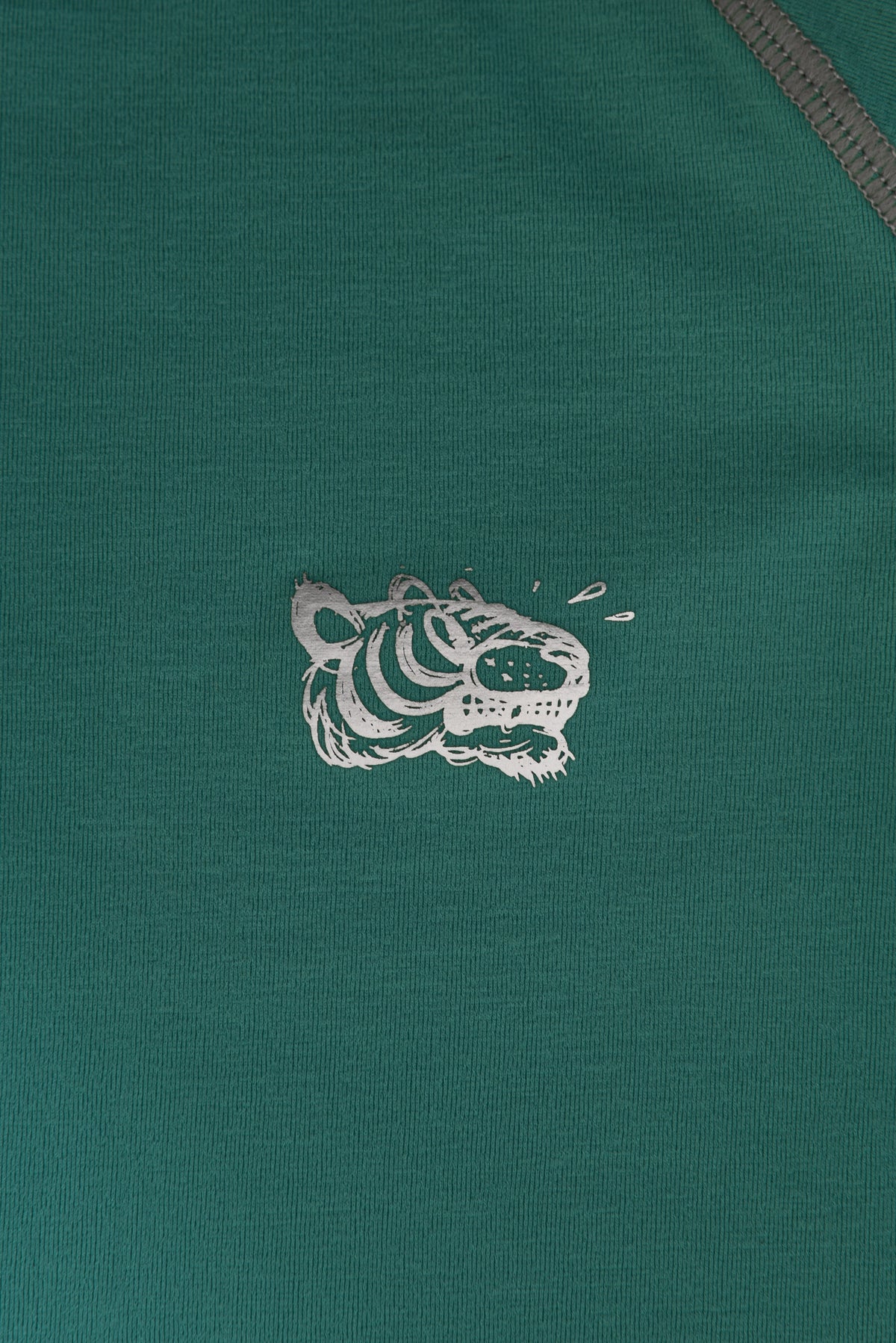 Green fabric with a reflective soulgoods  tiger logo on a green background