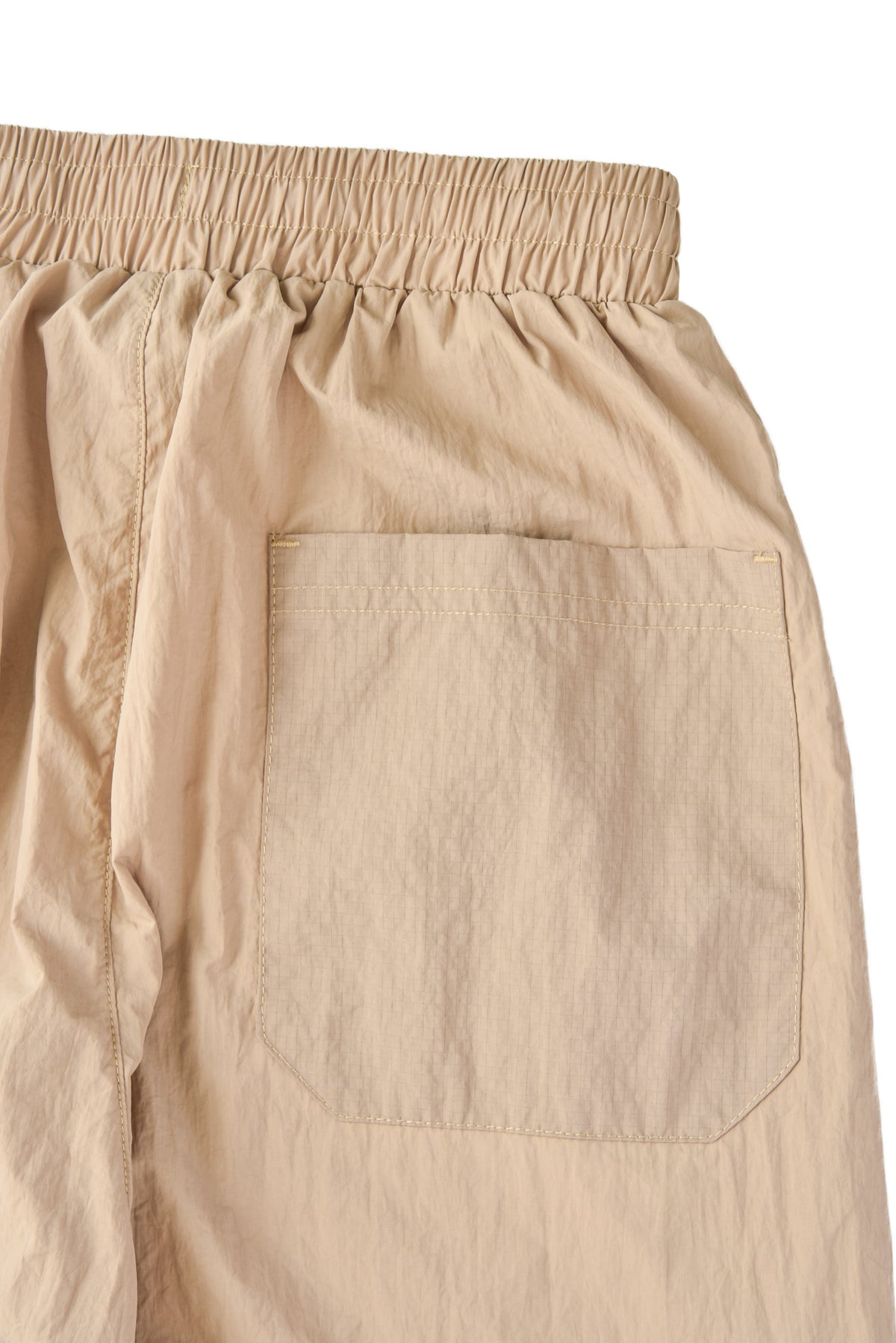 Beige pants with a pocket on a white background