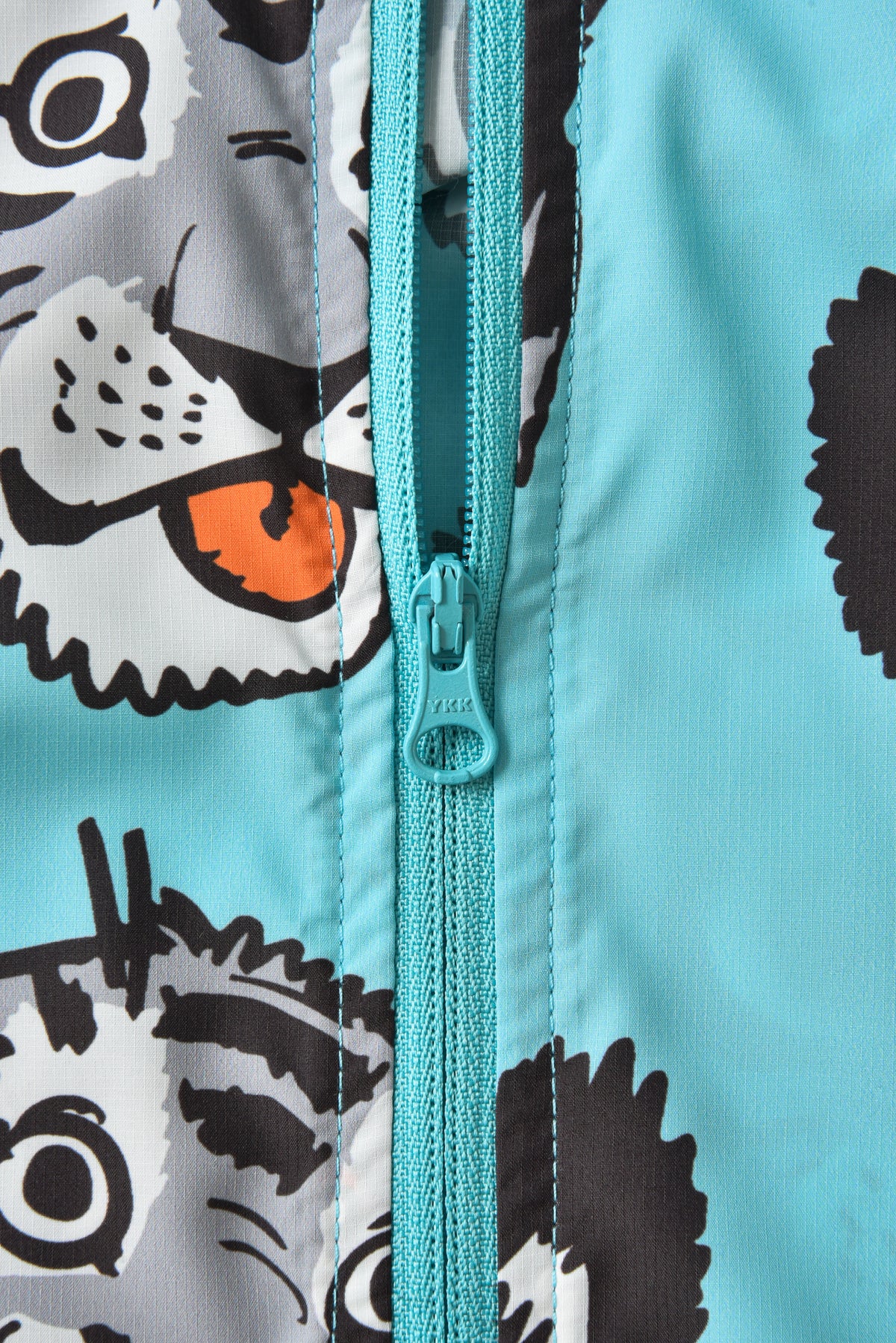 Close-up of a zipper on a jacket with cartoon soulgoods tiger pattern