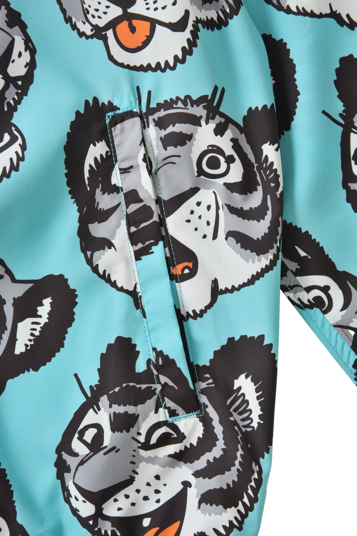 Close-up of fabric with cartoon soulgoods tiger pattern on a blue background