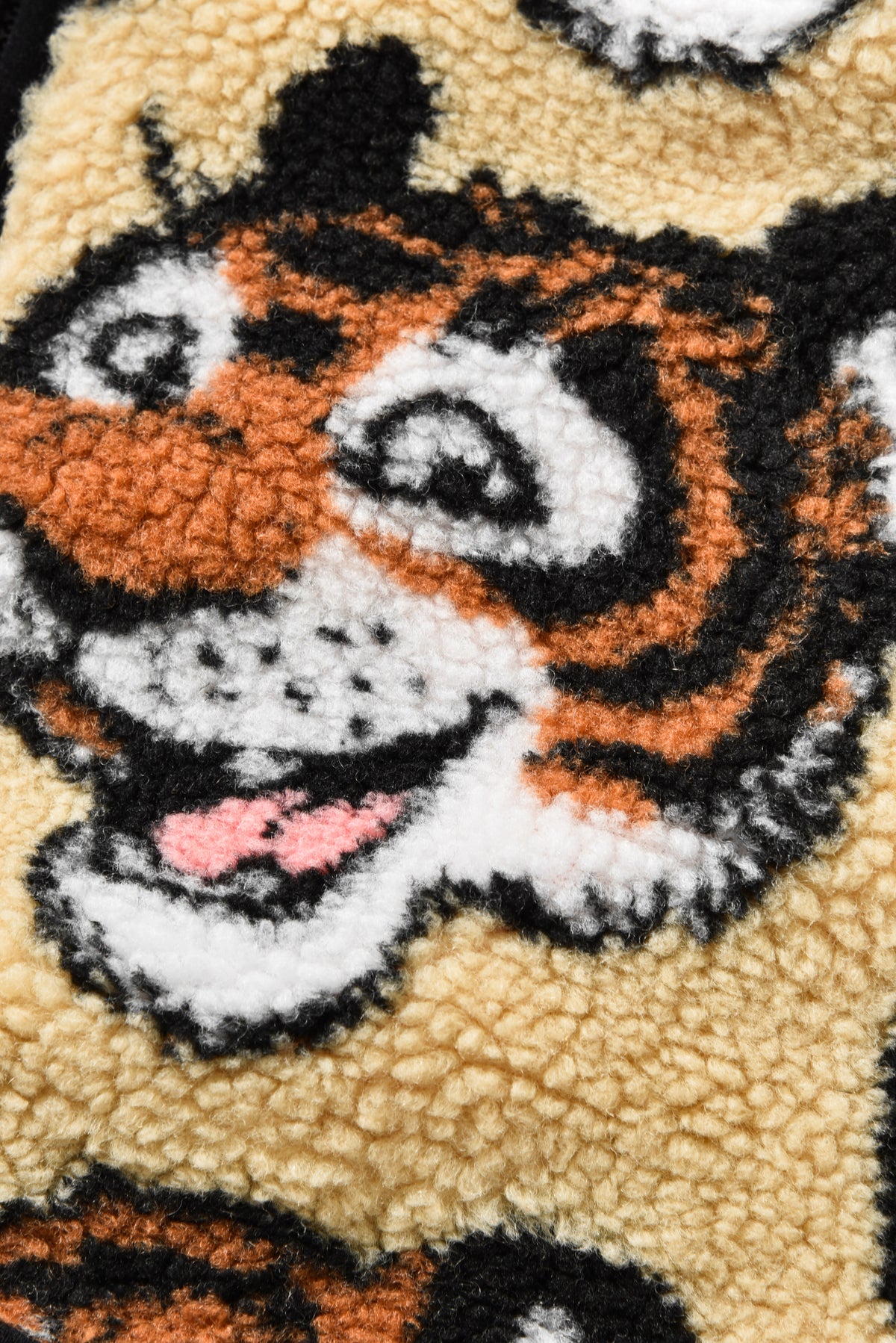 Close-up of a tiger face design on a textured fabric background