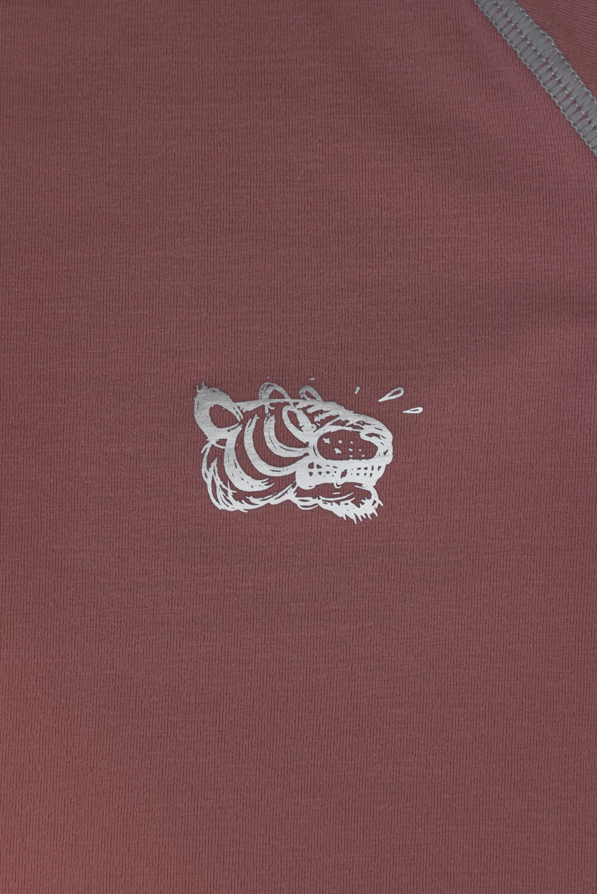 Maroon fabric with a white soulgoods tiger head logo on a red background