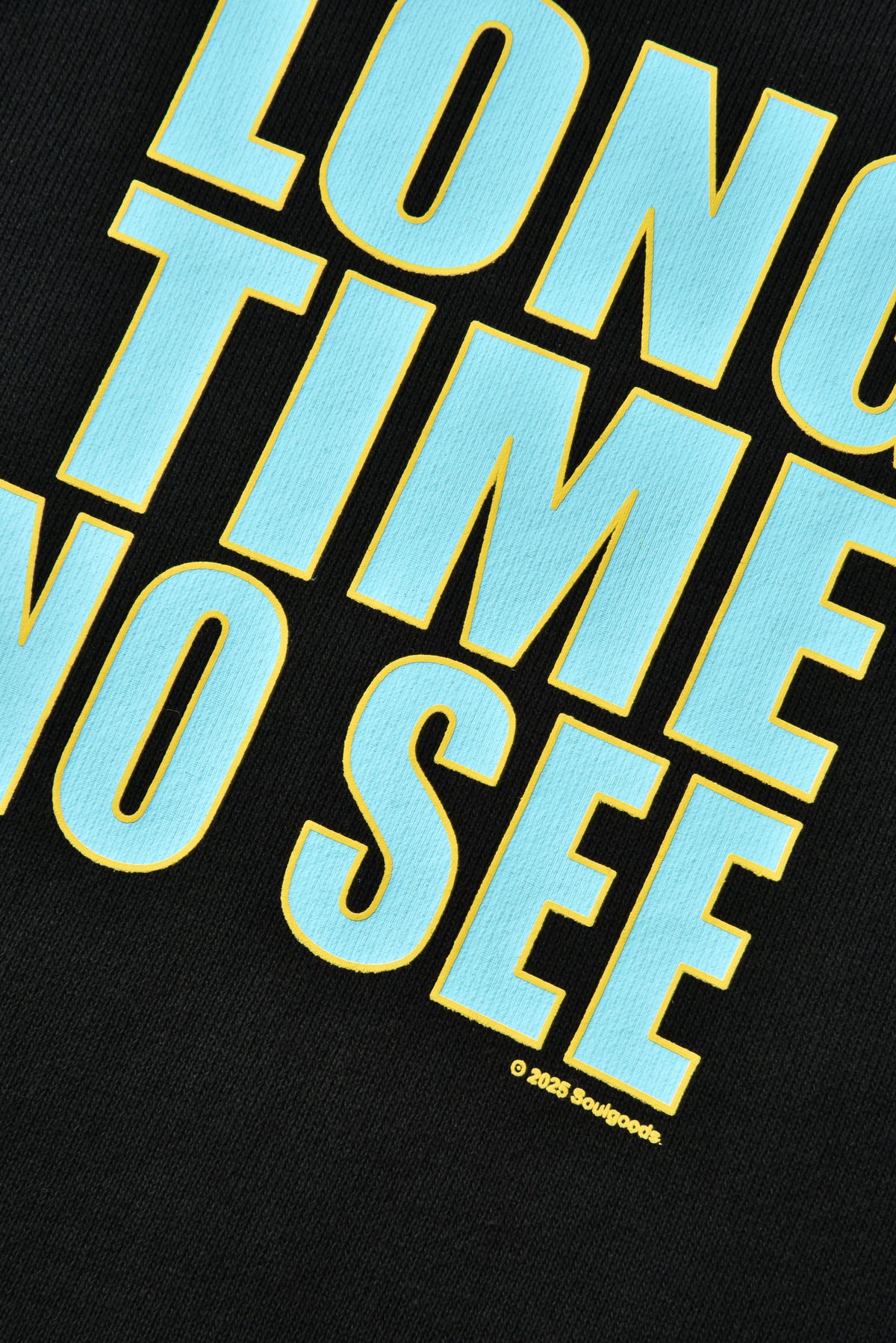 Black t-shirt with blue and yellow text 'LONG TIME NO SEE' on a black background