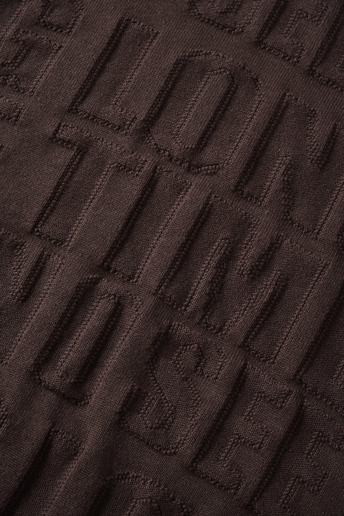 Close-up of a textured brown fabric surface
