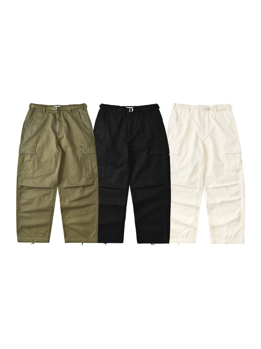 Three pairs of cargo pants in green, black, and beige on a white background