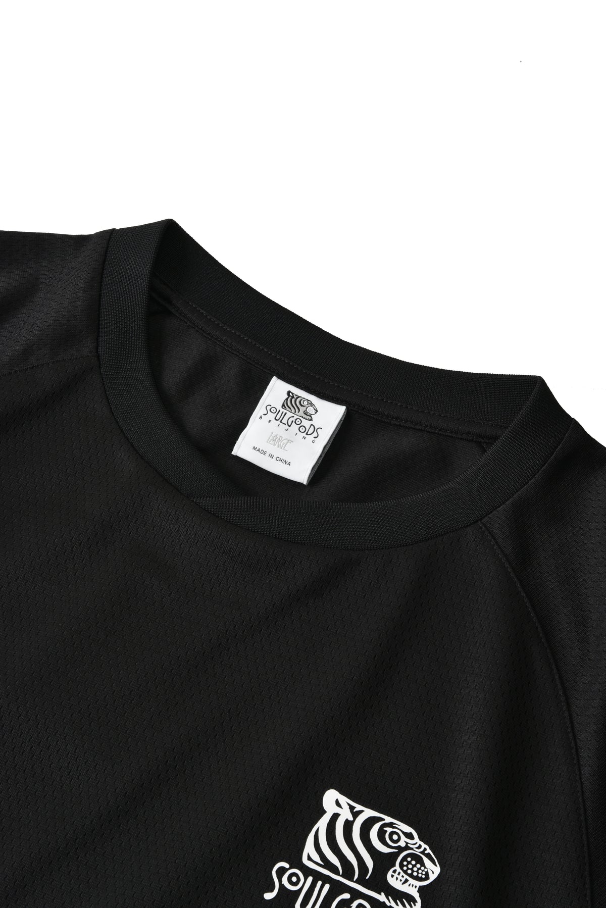 Black shirt with white tiger logo and brand label on a white background