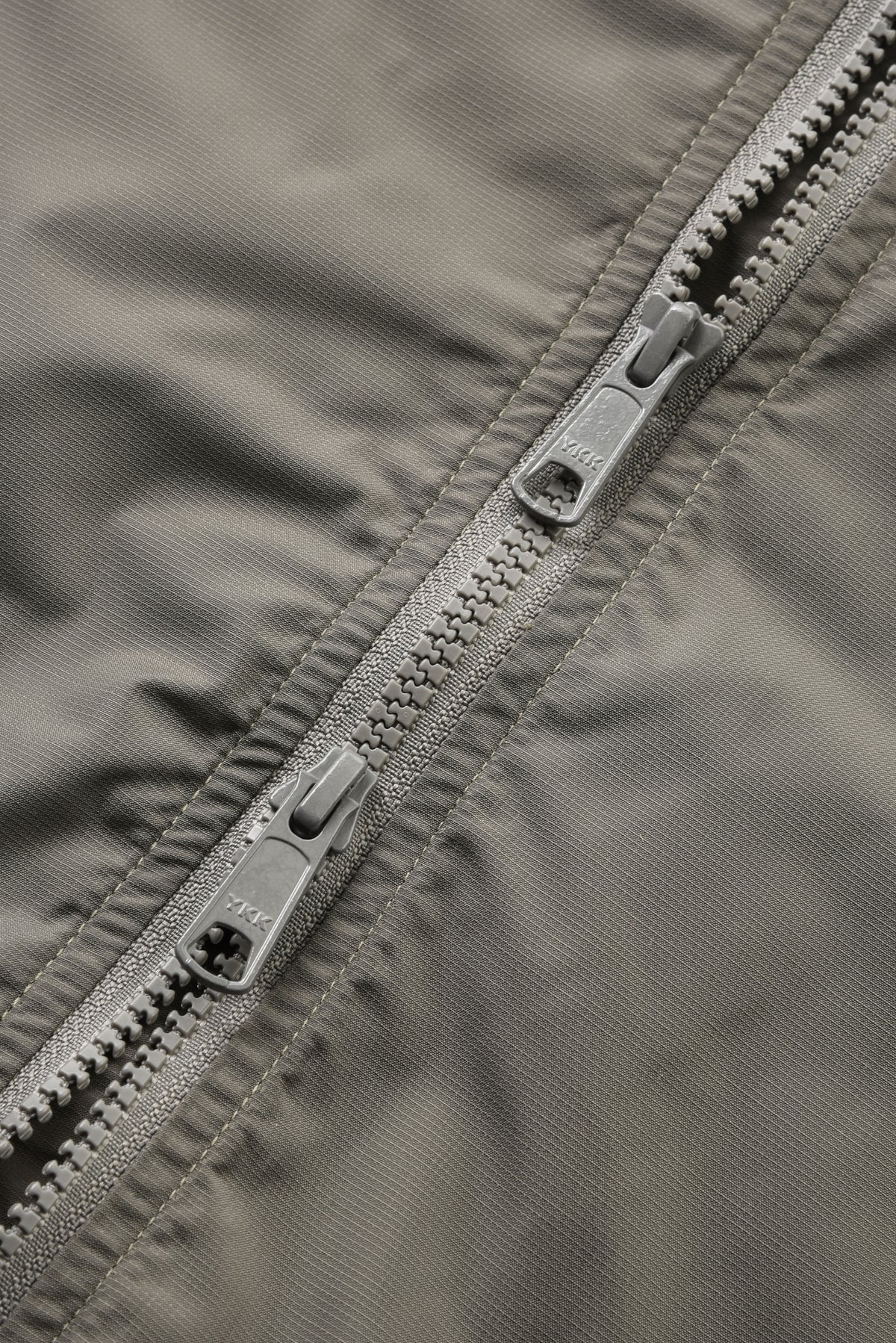 Close-up of a zipper on a gray jacket