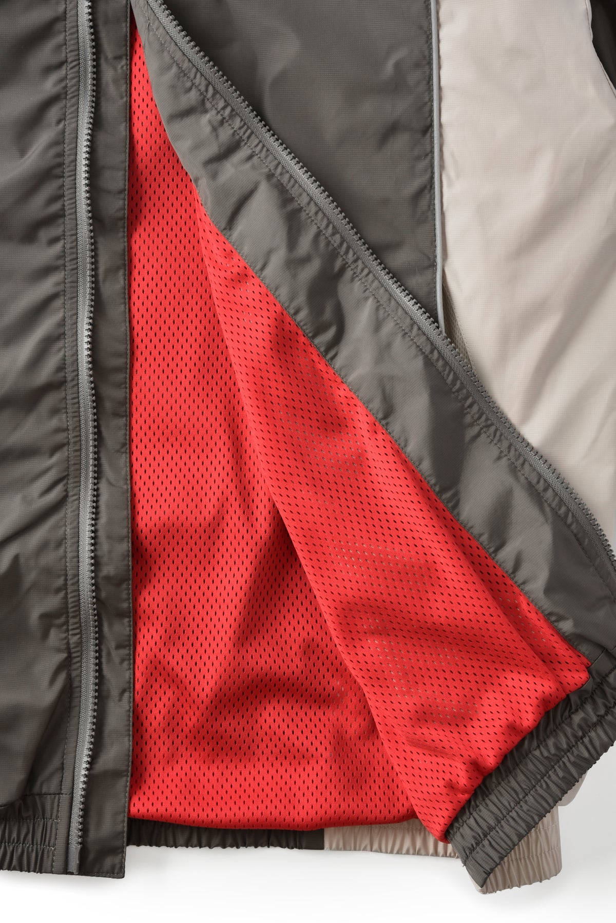 Close-up of a jacket with red lining and gray exterior