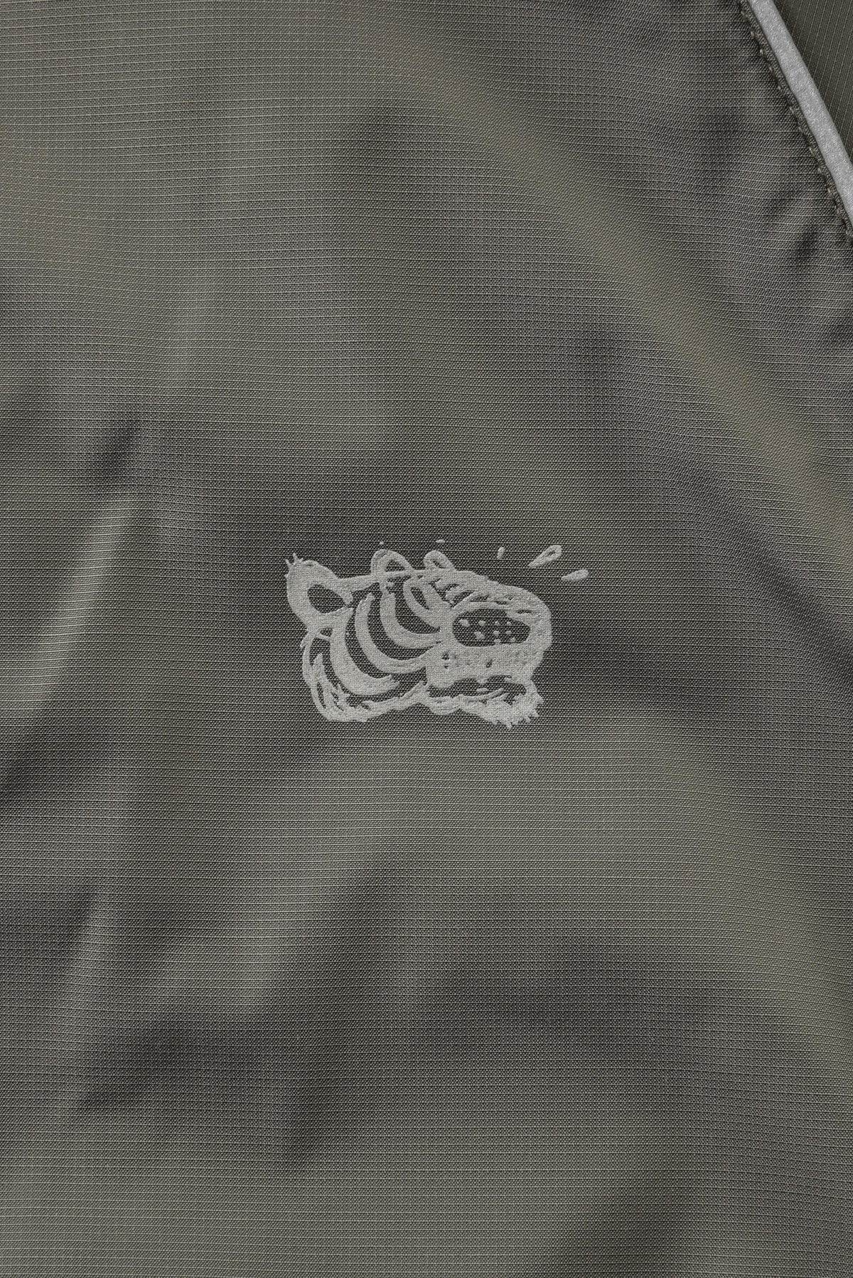 Embroidered soulgoods tiger head logo on a dark fabric background