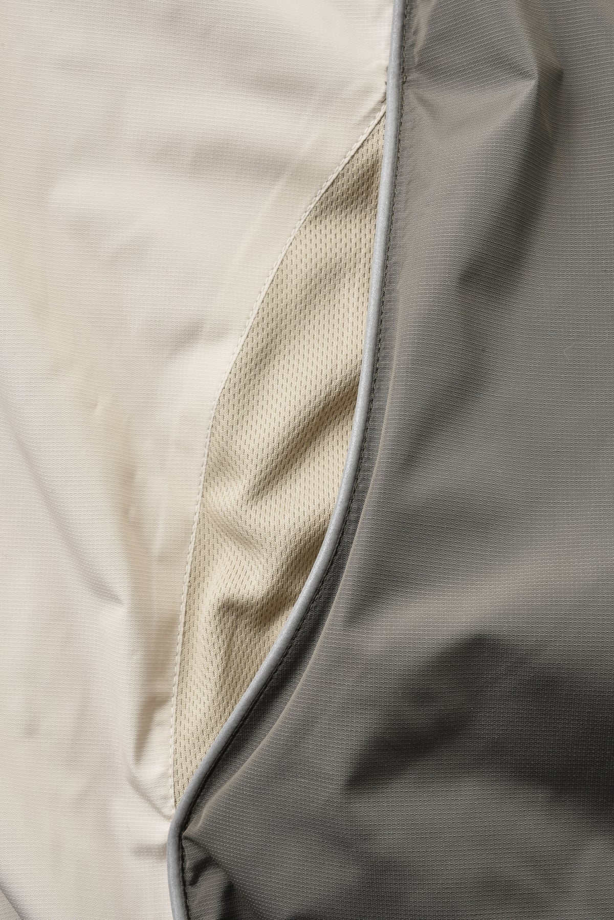 Close-up of a gray jacket with a textured interior lining.