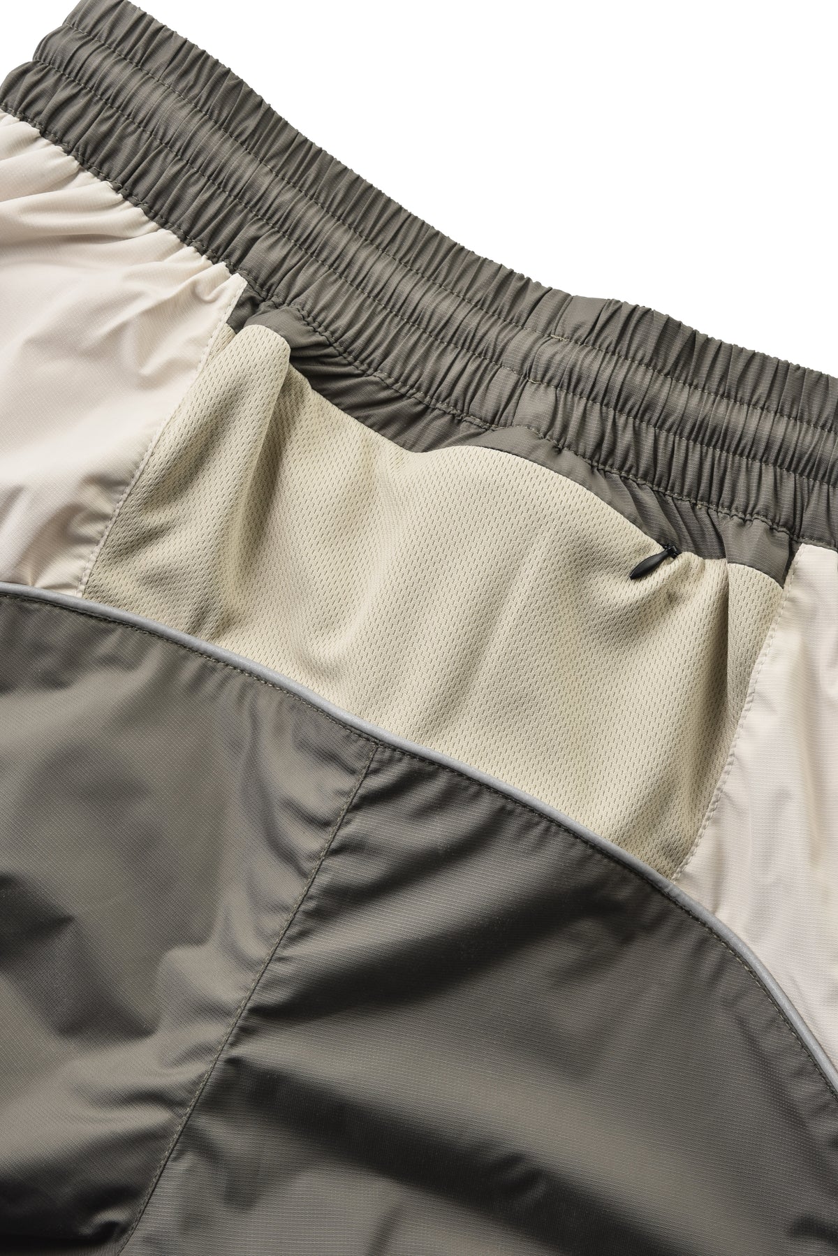 Close-up of a jacket with different fabric textures on a white background