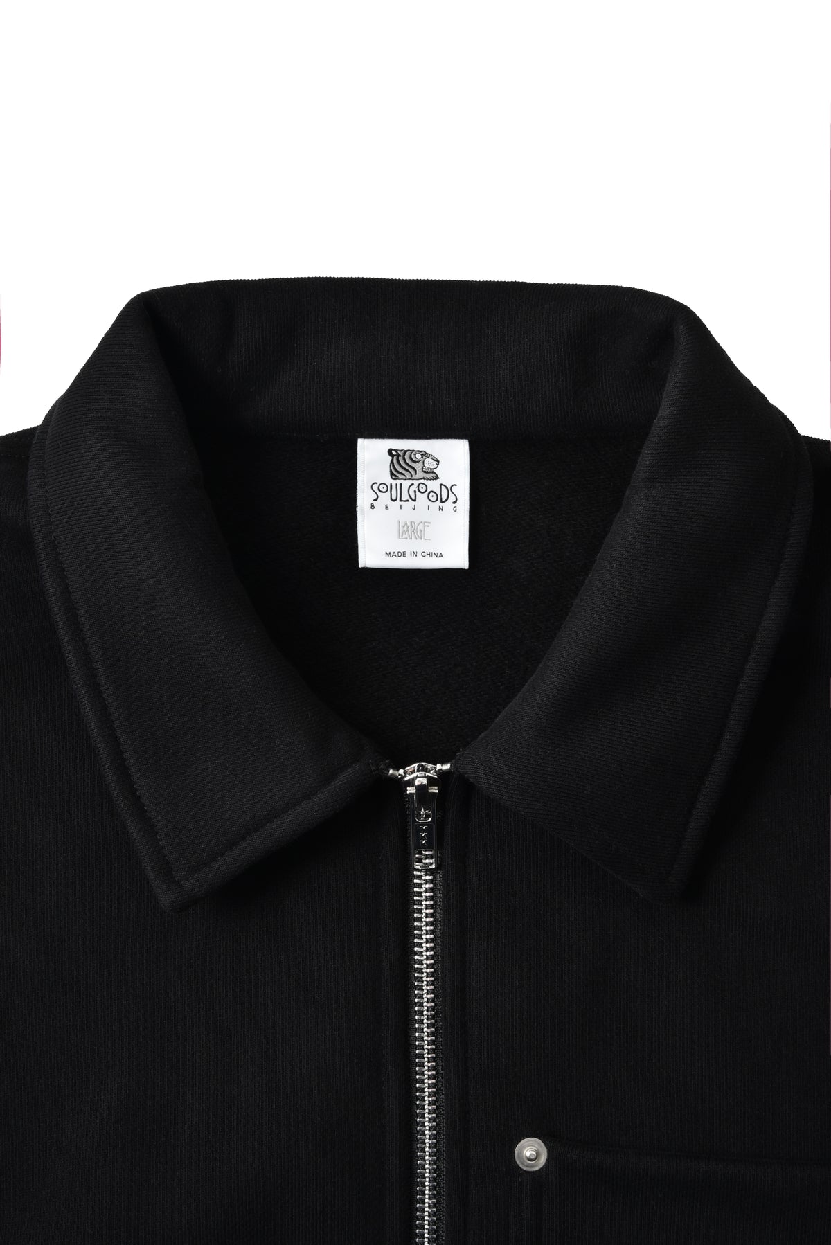 Black jacket with a zipper and visible soulgoods tiger head brand label on a white background