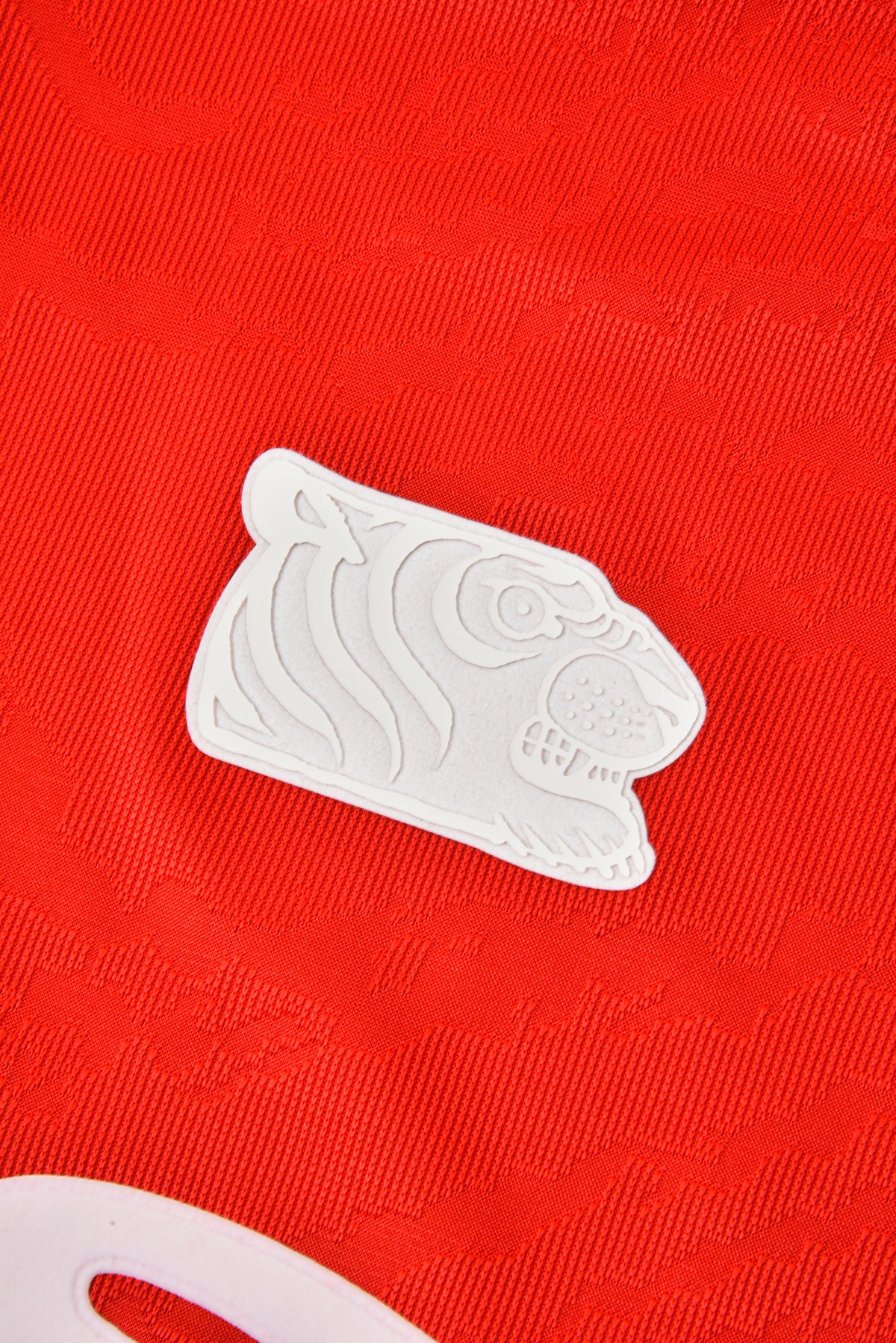 White soulgoods tiger head logo on a red background