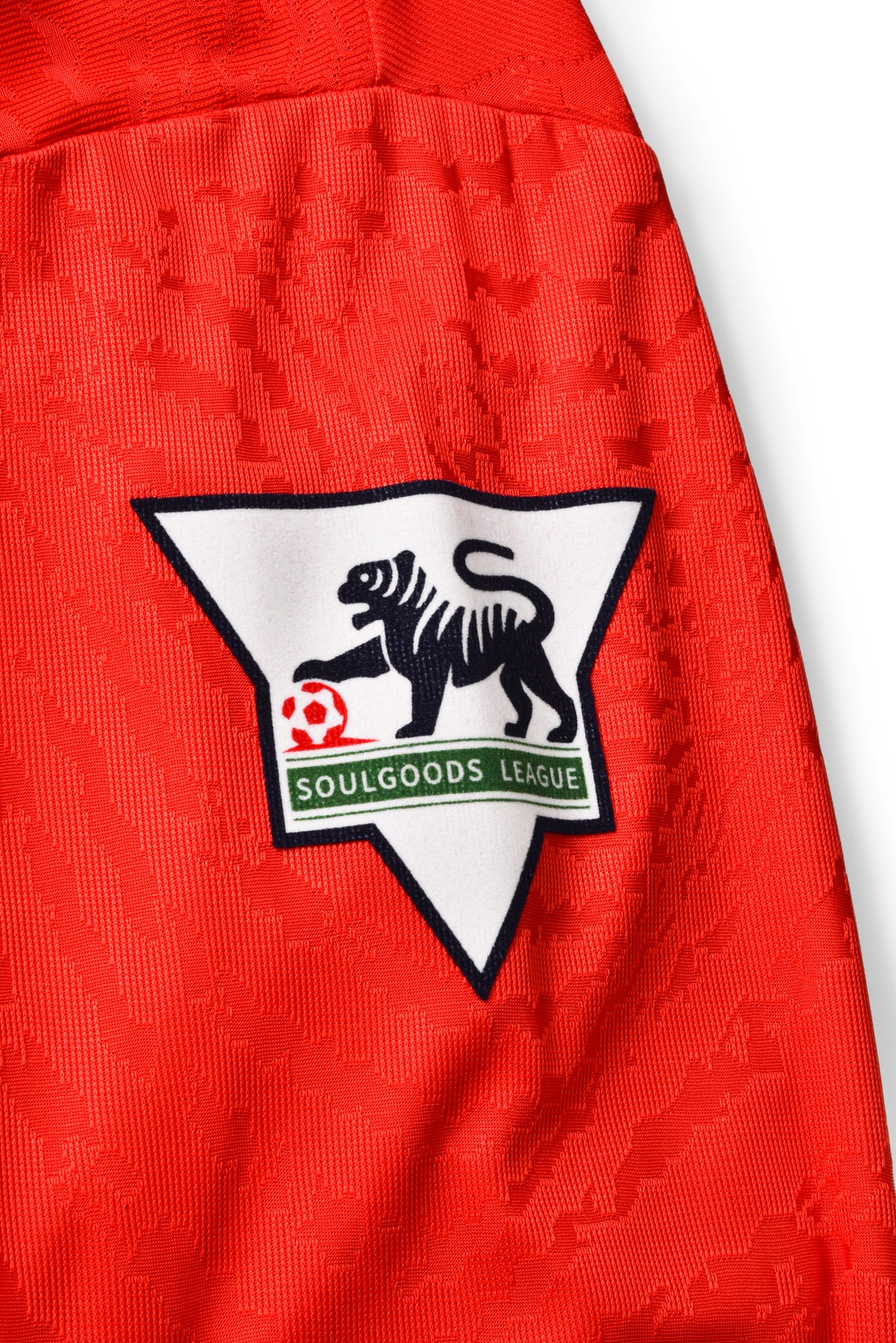 Red textured fabric with a black and white logo featuring a tiger and text on a white background