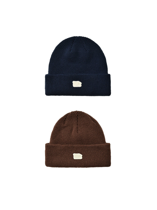 Two knit beanie hats, one navy and one brown, on a white background.
