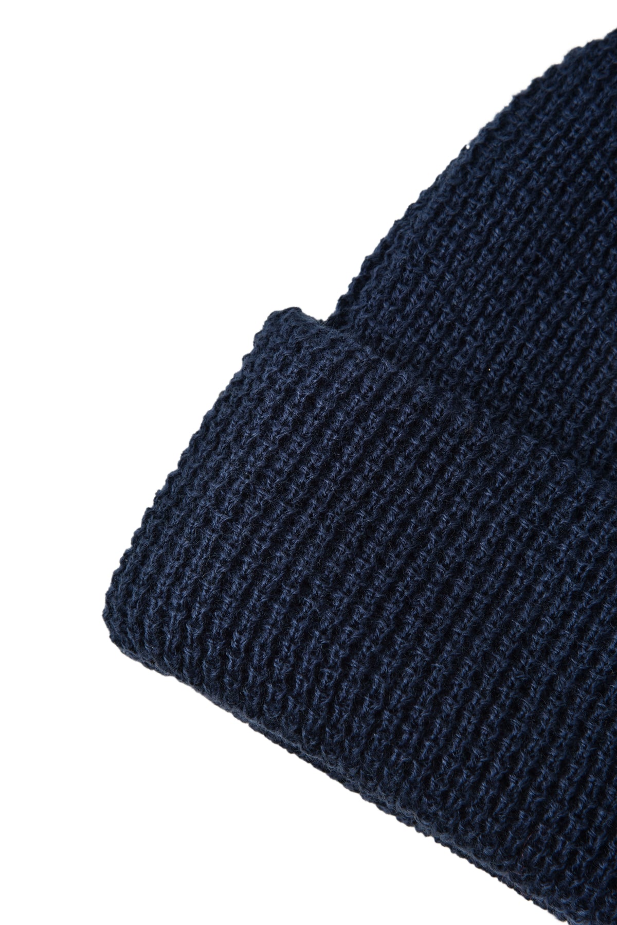 Close-up of a dark blue knitted fabric on a white background