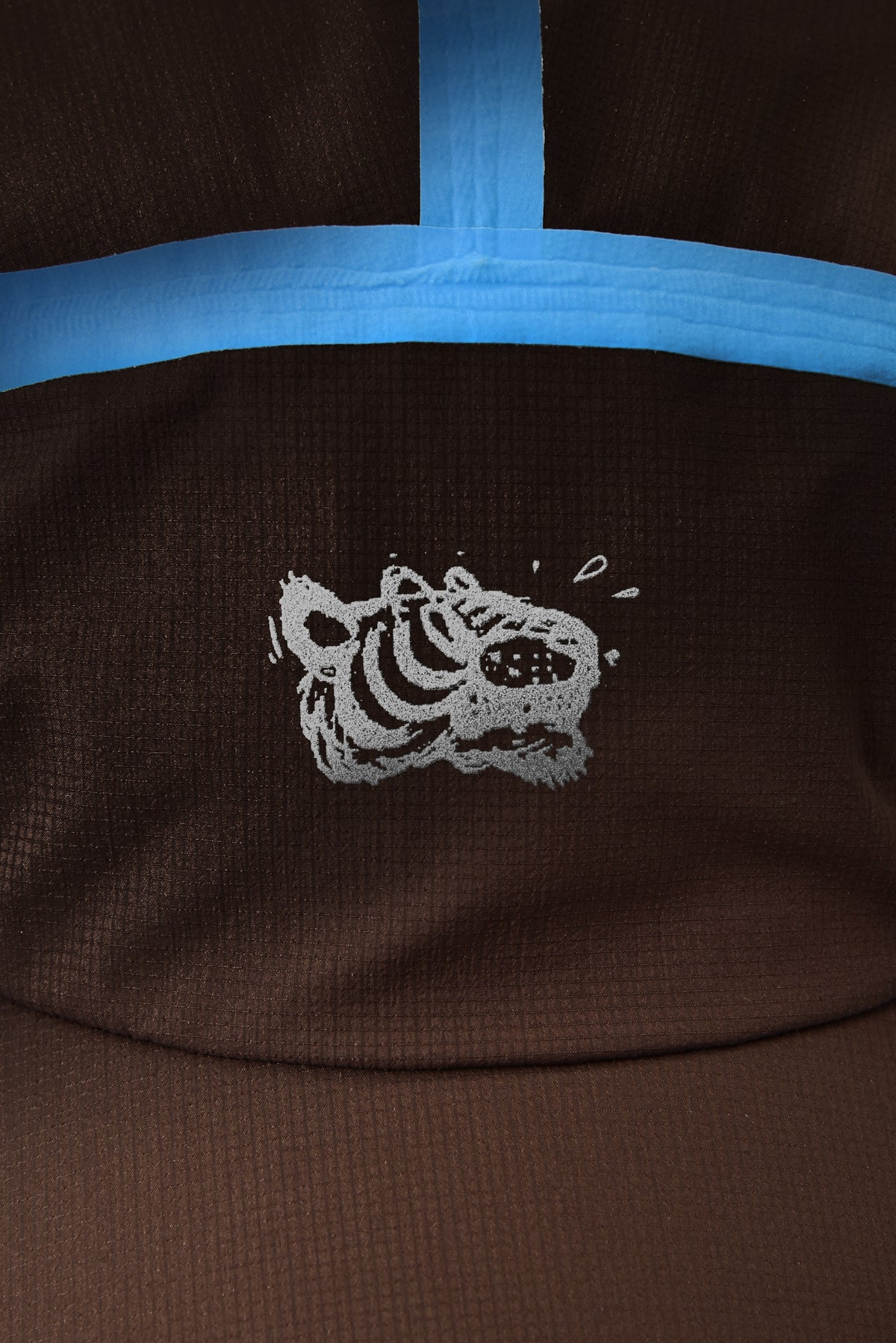 Brown fabric with a tiger logo on a dark brown background