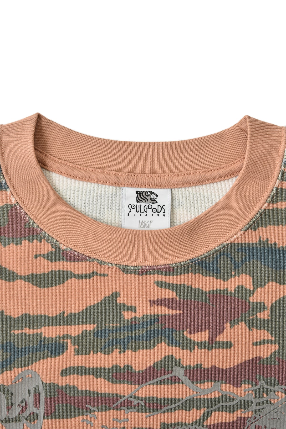 Camouflage-patterned shirt with a soulgoods brand label on a white background