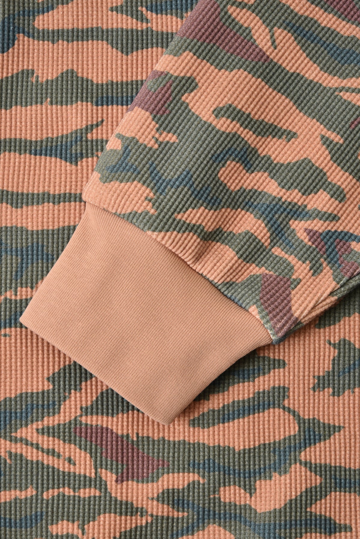 Camouflage-patterned fabric with a focus on texture and color variation.