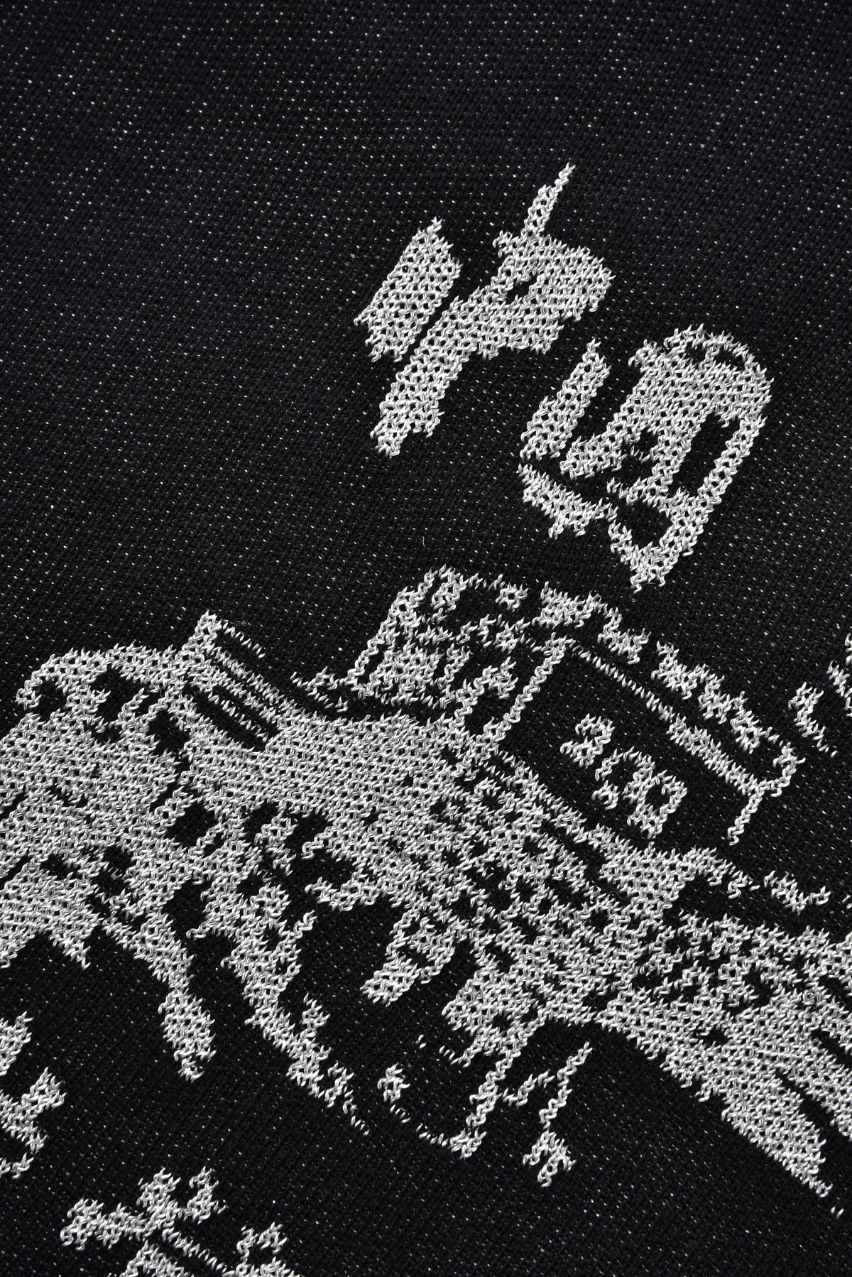 Graphic design on a black fabric with a horse and rider, and text (China).