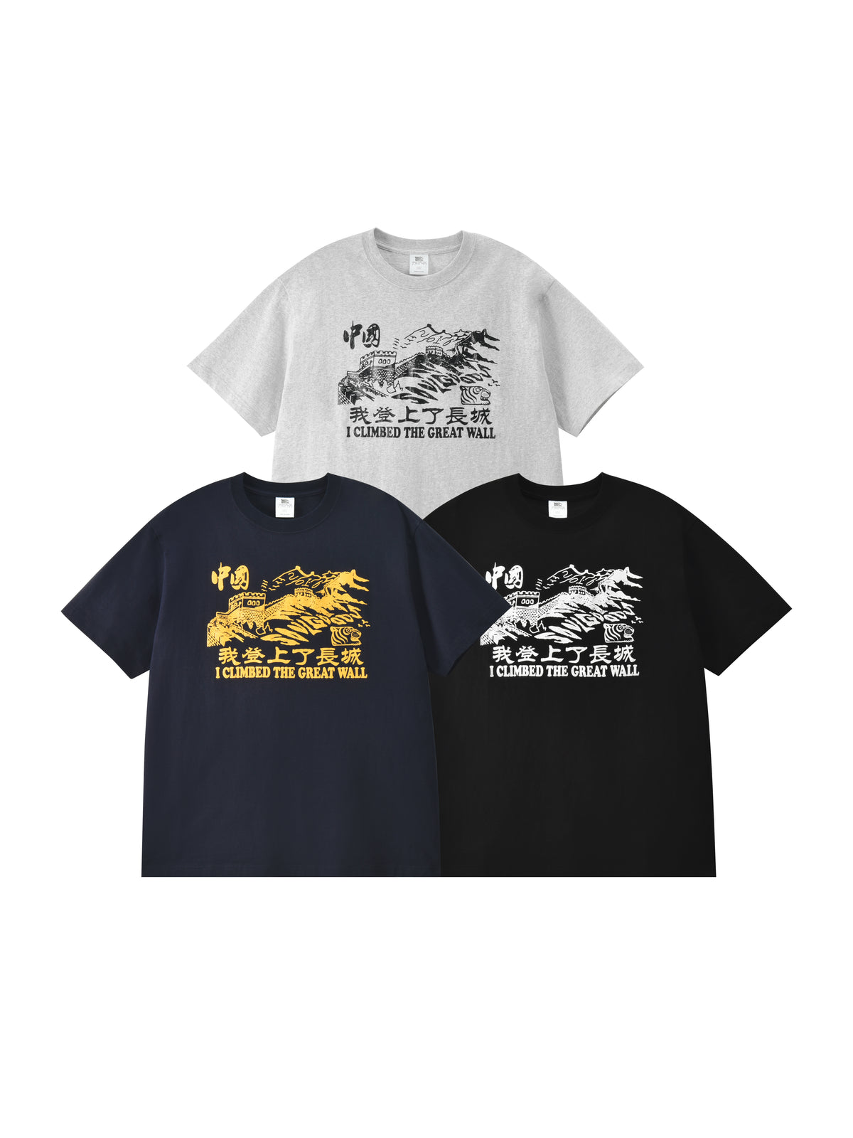 Three graphic T-shirts shown on a plain white background: one light gray shirt at the top with a black the great wall print and text, one dark navy shirt at lower left with a yellow print, and one black shirt at lower right with a white print.
