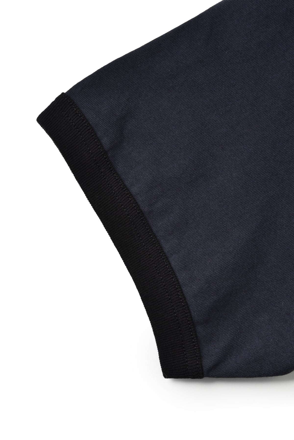 Close-up of a dark blue fabric with black trim on a white background