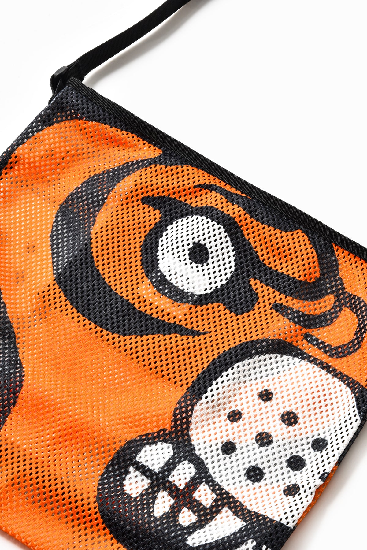 Close-up of a mesh bag featuring a bold orange and black tiger face graphic with white details, on a plain white background.