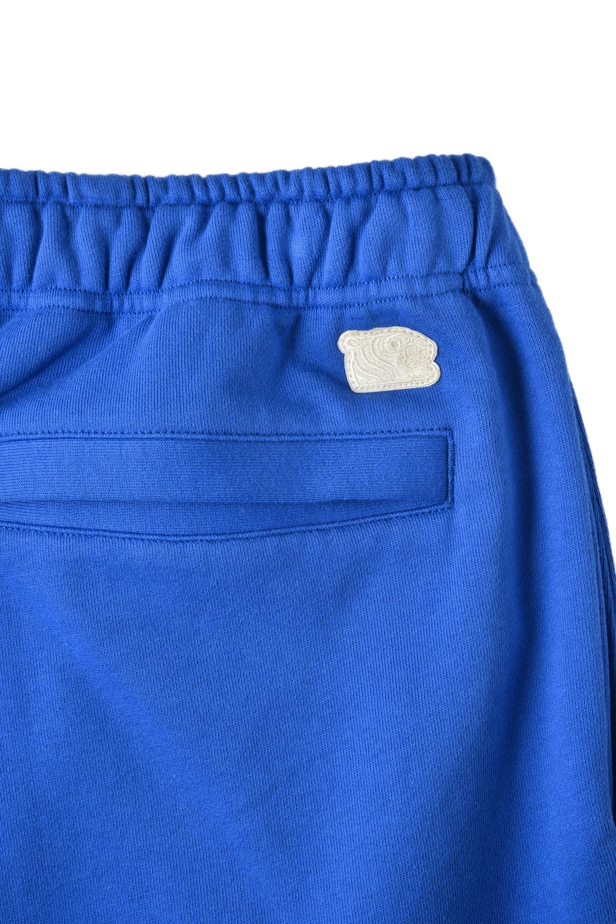 Blue shorts with a soulgoods tiger logo on a white background