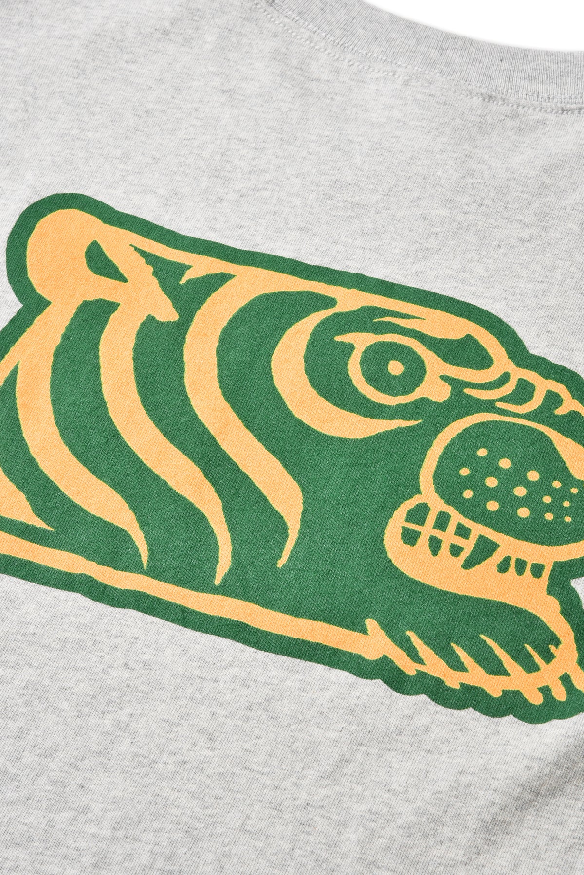 Close-up of a heather gray t-shirt featuring a large green and yellow tiger graphic on the chest.