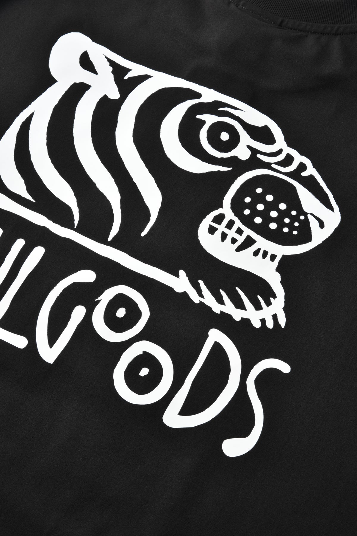 Close-up of a black T-shirt featuring a large white tiger head graphic and the word 'SOULGOODS' in white script across the lower portion.