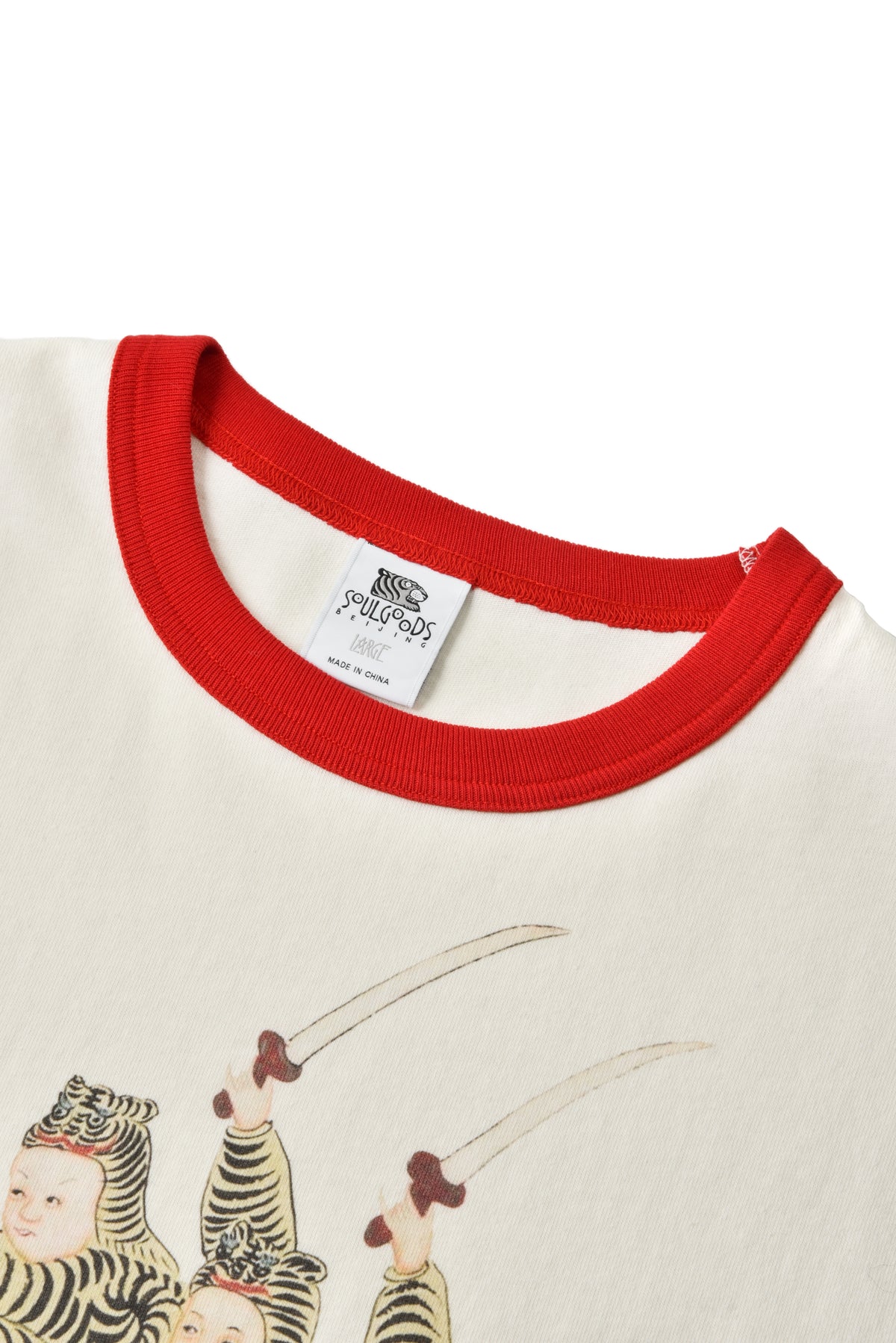 Close-up of a shirt with red collar and tiger-themed design on a white background