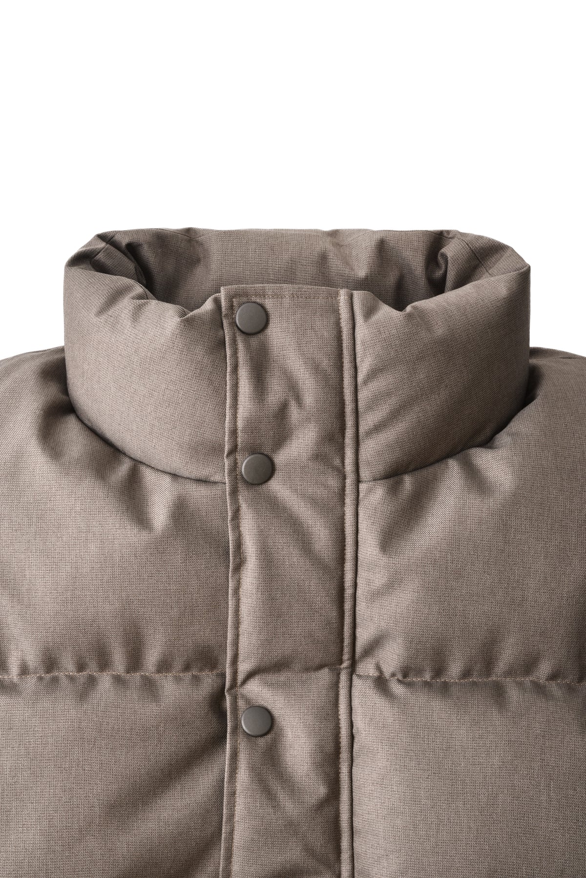 Close-up of a brown puffer vest with buttons on a white background