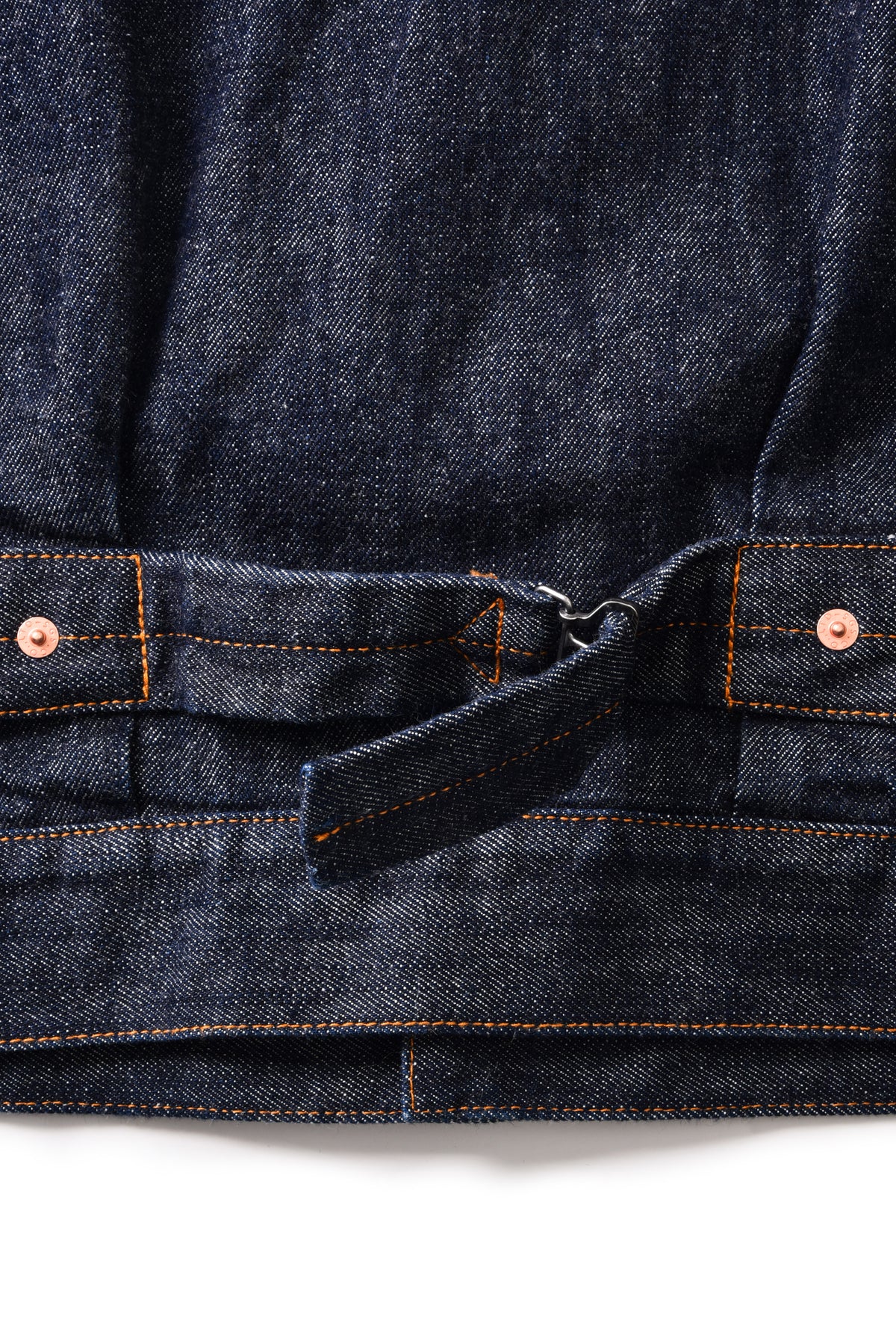 Close-up of a dark blue denim jacket with stitching details on a white background