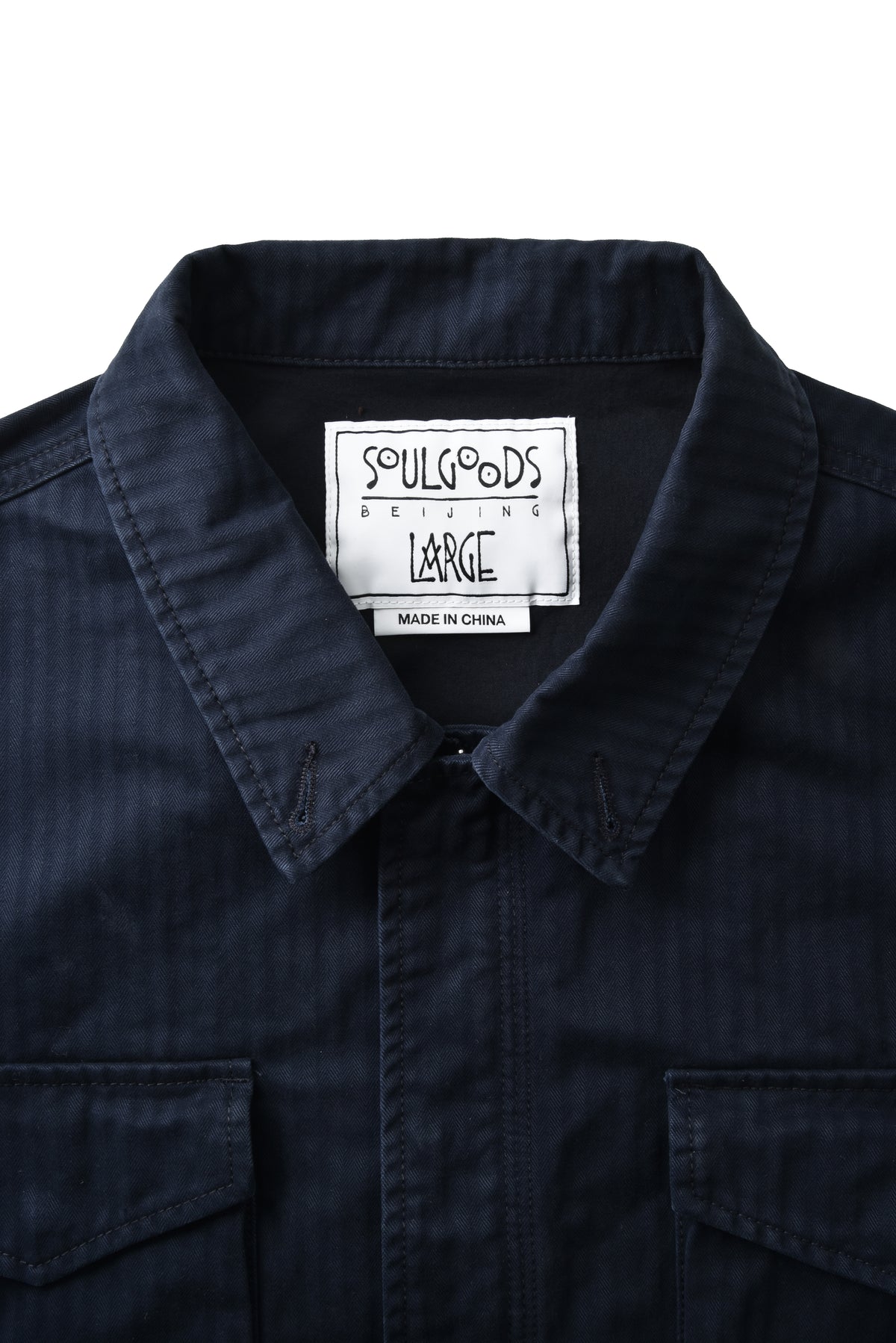 Navy blue shirt with a visible soulgoods label on a white background