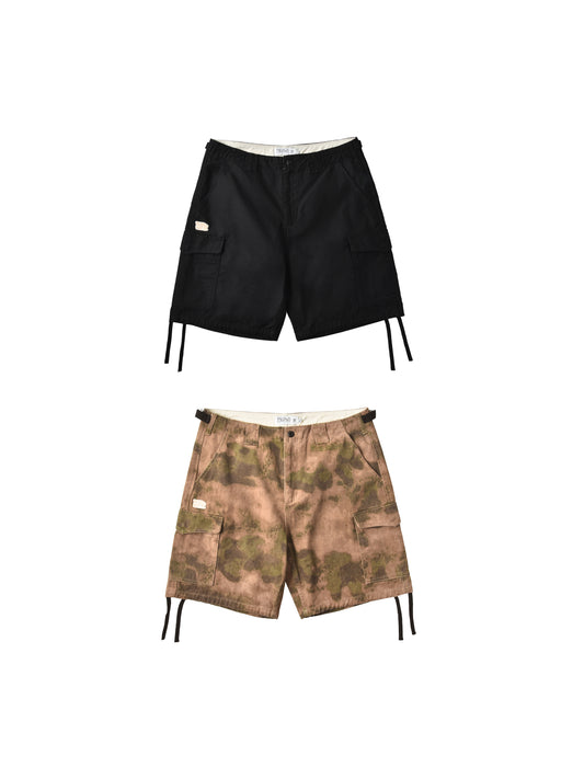 Two pairs of cargo-style shorts displayed on a plain white background: one solid black pair at the top and one tan and brown camouflage pair at the bottom. Both have side flap pockets and drawstring hems.