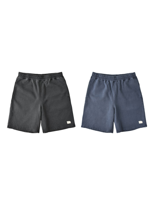 Two pairs of athletic shorts displayed side-by-side against a plain white background. The left pair is dark charcoal gray, and the right pair is slate blue.